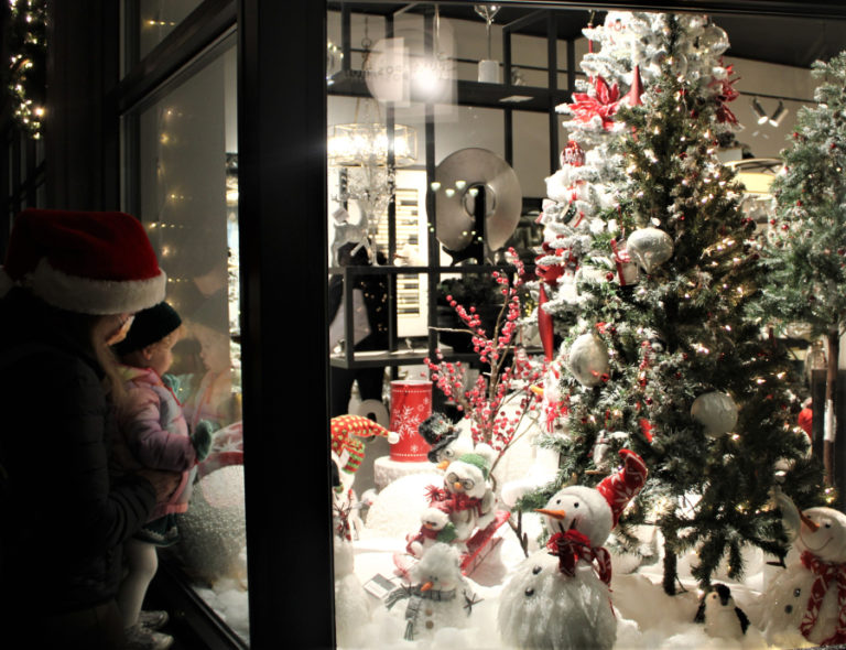 A family views a holiday display inside Juxtaposition in downtown Camas during the city's 2021 Hometown Holidays celebration on Dec. 3, 2021.