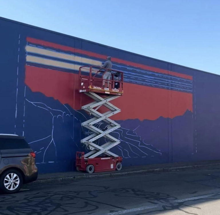 Contributed photo courtesy Travis London 
 Washougal artist Travis London paints a mural on the north side of the Pendleton Woolen Mills building in Washougal in September. (Contributed photo courtesy of the city of Washougal)