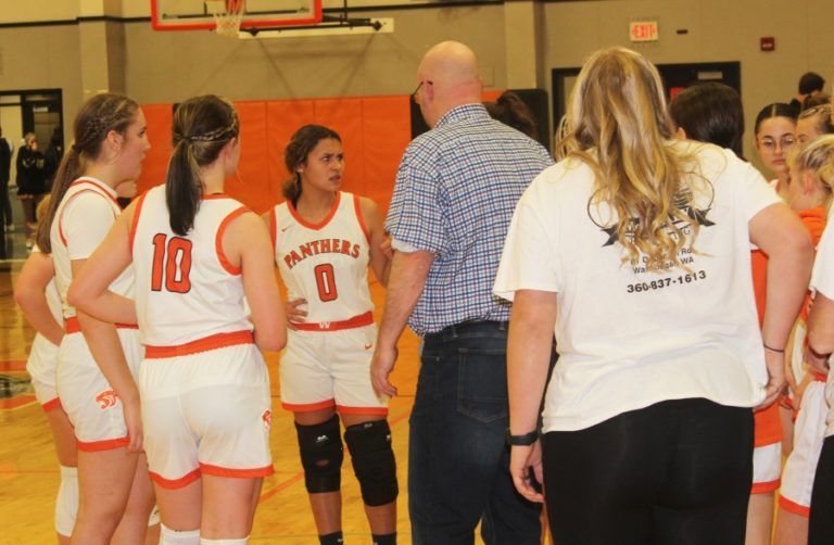 Washougal High School senior point guard Chloe Johnson (0) talks to the Panthers&#039; coach, Tim Melcher, and teammates during the second half of Washougal&#039;s home game against Tumwater on Friday, Dec. 2, 2022.