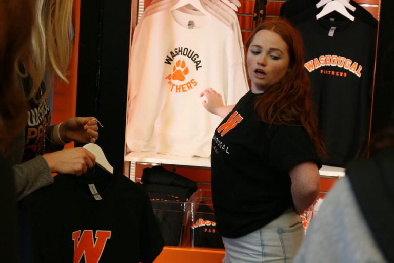 Washougal High School marketing student Samantha Mcray-Smith assists a customer at the Washougal Co student store in November.