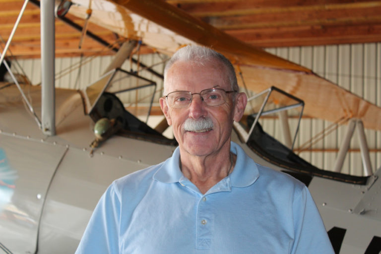 Camas resident Kent Mehrer stands inside one of his airplane hangars in 2018. The Port of Camas-Washougal has agreed to purchase Mehrer&#039;s Grove Field-adjacent property, which includes a house and two hangars, for future development.