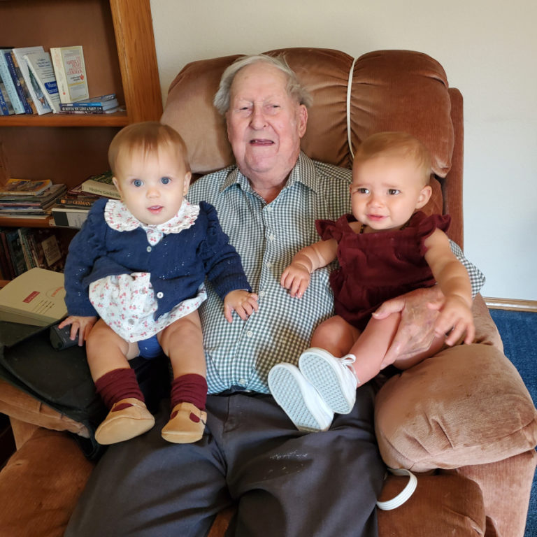 Ken Shold holds his two youngest great-great-grandchildren, 11-month-old Magnolia (left) and Cheyene, 1, in September 2022.