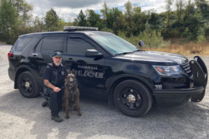 Washougal Police Department Detective Sergeant Kyle Day kneels beside his K-9 partner, Ranger, in 2022. Ranger, a Dutch shepherd, retired in November 2022. (Contributed photo courtesy of Kyle Day)