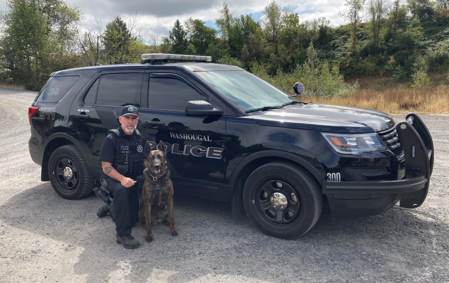 Washougal Police Department Detective Sergeant Kyle Day kneels beside his K-9 partner, Ranger, in 2022. Ranger, a Dutch shepherd, retired in November 2022. (Contributed photo courtesy of Kyle Day)