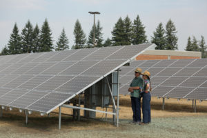 Clark Public Utilities workers inspect a community solar project constructed in 2015, in Vancouver's Orchards neighborhood. (Contributed photo courtesy of Clark Public Utilities)