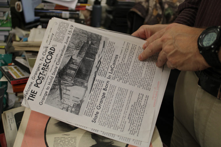 A Camas library employee researches copies of old Camas Post-Record newspapers inside the Camas Public Library building on Friday, Oct. 28, 2022.