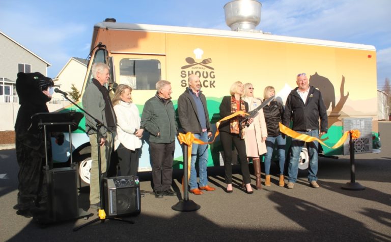 Doug Flanagan/Post-Record 
 Washougal School District  Superintendent Mary Templeton (fourth from right) cuts a ribbon as Washougal Scool Board members Jim Cooper (far left), Angela Hancock (second from left), Chuck Carpenter (third from left), Cory Chase (fourth from left) and Sadie McKenzie (second from right), Washougal Mayor David Stuebe (far right) and Washougal School District career and tecnnical education director Margaret Rice (third from right) look on at Washougal High School on Thursday, Feb. 2, during a ceremony celebrating the opening of the district&#039;s Shoug Shack food-truck business.