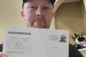 Washougal resident Randall Crane holds his latest utilities bill from the city of Washougal. Crane has launched a community effort to demand fair utility rates and billing practices from the City. (Contributed photo courtesy Randall Crane)