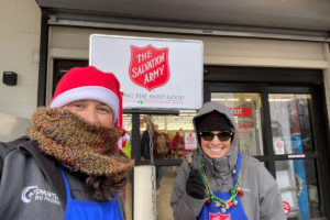 Salvation Army of Camas-Washougal volunteers Richard Sweet (left) and Cindy Schroeder (right) ring bells in front of the Bi-Mart store in Washougal in December 2022.