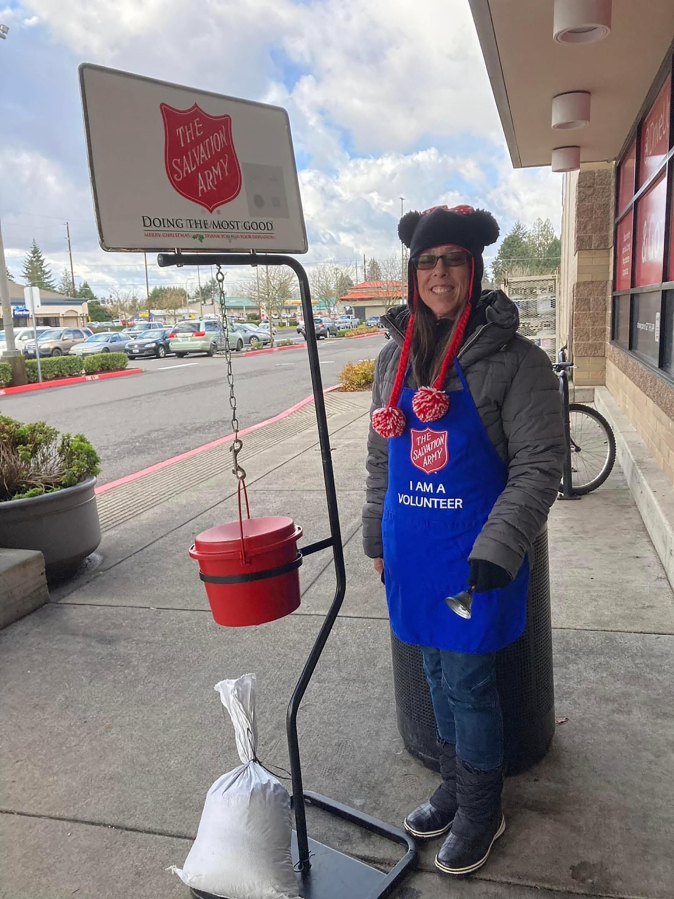 Top: A Salvation Army of Camas-Washougal volunteer rings a bell near one of the organization&#039;s infamous red kettles in December 2022.