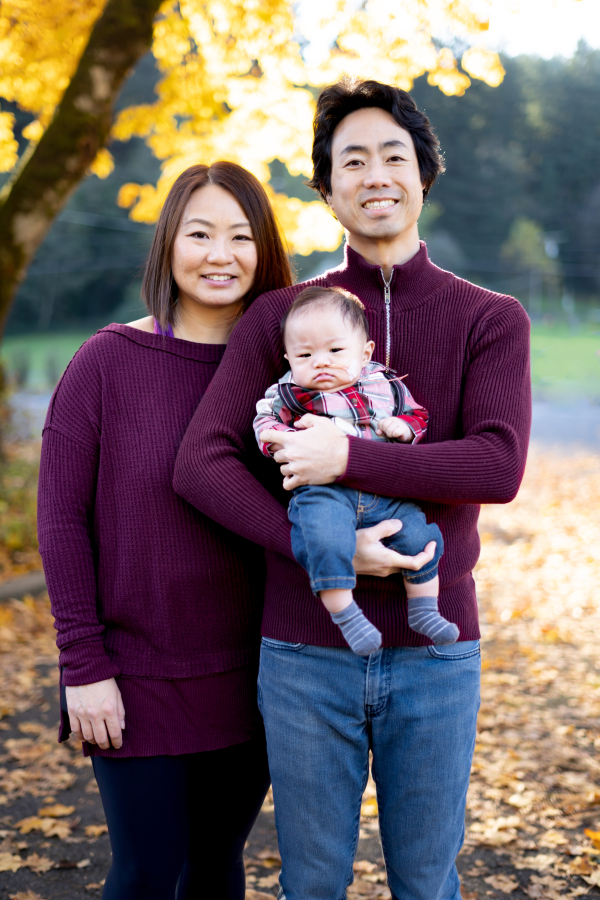 Christy Shum (left) and David Feng, of Camas, hold their son, Theo Feng, born in July 2022.