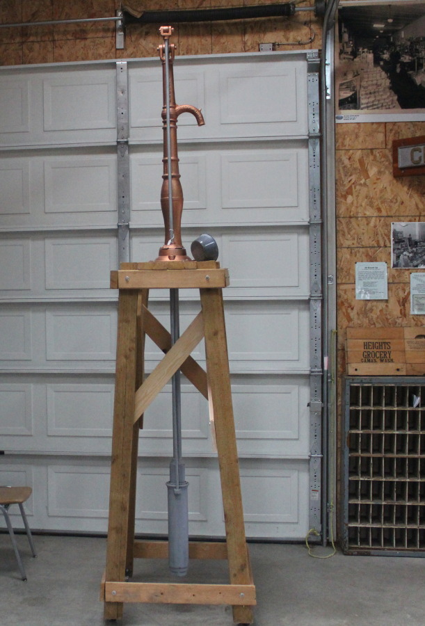 Doug Flanagan/Post-Record 
 Two Rivers Heritage Museum volunteers moved the museum&#039;s old water pump from the main building to the Carriage House in an effort to give it more visibility.  &quot;It will be on display in a different light,&quot; said museum volunteer Richard Johnson. &quot;I think it was missed here in the building because it was mixed with all that activity on that wall, but when you look at it out there, it really jumps out at you. It&#039;s very three- dimensional. I think it&#039;s going to be an (improvement).&quot;