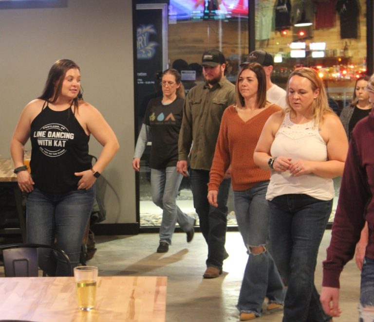 Kat Nichols (left) leads a line-dancing class at Ashwood Taps and Trucks in Washougal, on Wednesday, March 1, 2023.