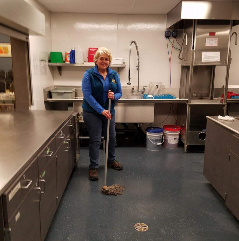 Washougal City Councilwoman and former Mayor Molly Coston cleans the Washougal Community Center&#039;s kitchen after a ReFuel Washougal weekly meal.