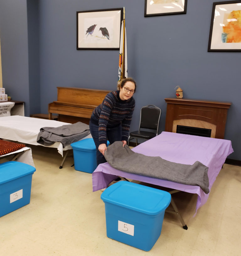 ReFuel Washougal volunteer Lynette Kamakura makes a bed at the nonprofit organization&#039;s severe weather shelter at the Washougal Community Center earlier this year.