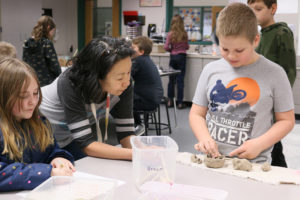 Canyon Creek Middle and Cape Horn-Skye Elementary school art teacher Alice Yang helps students with their projects in early 2023. (Photo courtesy of the Washougal School District) 