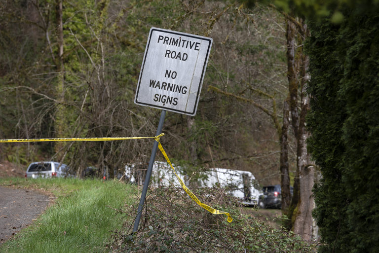 Crime scene tape is pictured at the entrance to Wooding Road east of Washougal on Wednesday afternoon, May 22, 2023. Authorities found two bodies believed to be those of a missing Vancouver woman and her 7-year-old daughter in the rural area.