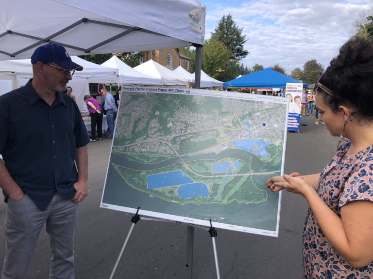 Marty Snell (left) and Kalanie Cox, members of the Citizen Advisory Group working to inform the public about an ongoing environmental cleanup process at the Georgia-Pacific paper mill in Camas work at a CAG booth at the Camas Farmer&#039;s Market in 2022.