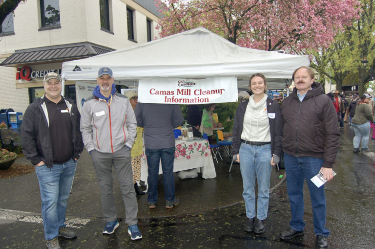 Members of the Citizen Advisory Group working to inform the public about an ongoing environmental cleanup process at the Georgia-Pacific paper mill in Camas work at a CAG booth at the Camas plant and garden fair in 2022.