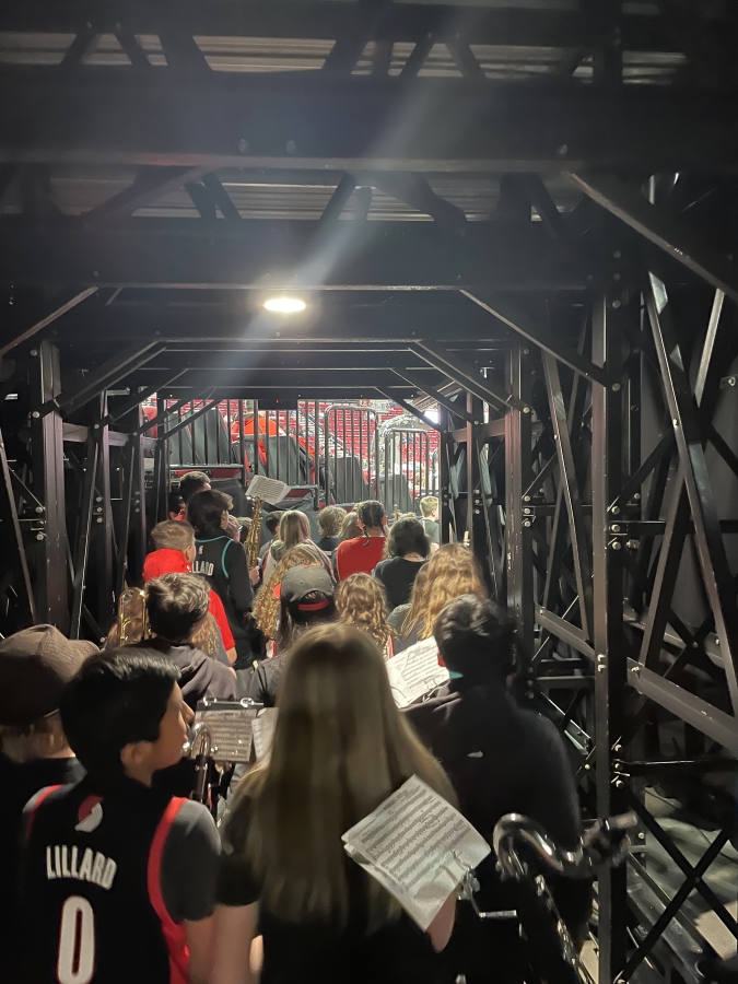 Members of the Jemtegaard Middle School wind ensemble walk through a tunnel to center court of the Moda Center in Portland before the start of the Portland Trail Blazers' game against the Sacramento Kings on Wednesday, March 29, 2023.
