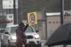 A "vote no on Washougal School Levy" supporter waves a sign on the corner of "E" Street and Washougal River Road on Monday, April 10, 2023. (Doug Flanagan/Post-Record)