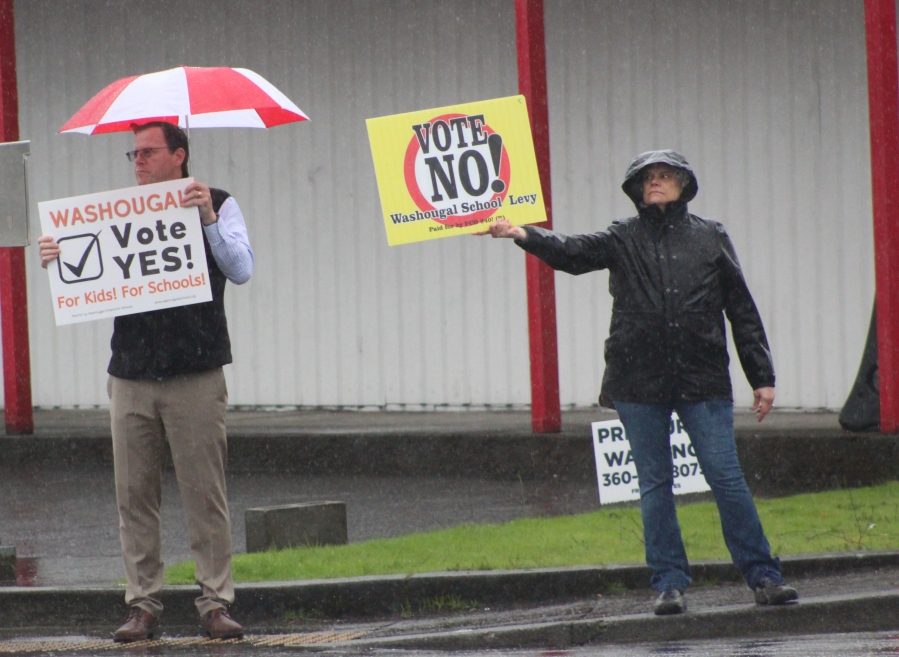 Doug Flanagan/Post-Record 
 A group of Washougal School District levy supporters, including superintendent Mary Templeton (far left) and Washougal School Board member Sadie McKenzie (second from left), wave signs at the northwest corner of 32nd and 