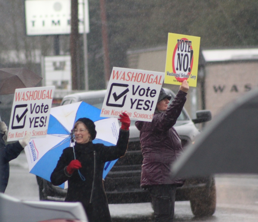 Doug Flanagan/Post-Record 
 Washougal School District assistant superintendent Aaron Hansen (left) waves a 