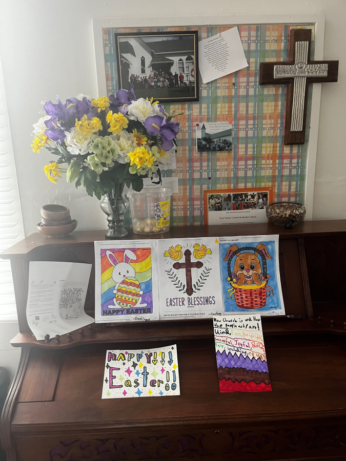 Children's artwork sits alongside flowers and historic photos inside the Fern Prairie United Methodist Church on Monday, April 17, 2023.