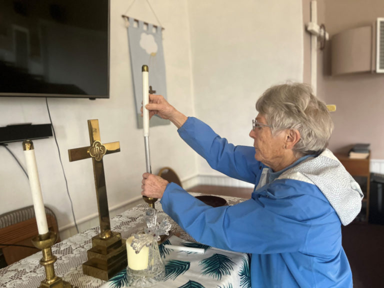Kathy Kahlar, a lay leader at the Fern Prairie United Methodist Church, puts a candle into a candleholder at the historic Camas-area church on Monday, April 17, 2023.