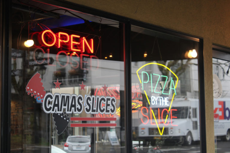 A sign hangs in the Camas Slices restaurant window in downtown Camas in April 2021.