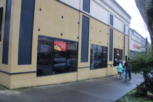 A family passes by Camas Slices in downtown Camas on April 10, 2021. A holding company affiliated with the nearby Journey Community Church recently purchased the former Camas Slices building on the corner of Northeast Cedar Street and Northeast Fourth Avenue in downtown Camas, as well as the adjacent building that once housed a State Farm insurance office. Church leaders say they plan to host community focus groups this spring to help gather ideas about how it might turn the former pizza shop into a youth-centered space. (Kelly Moyer/Post-Record files)