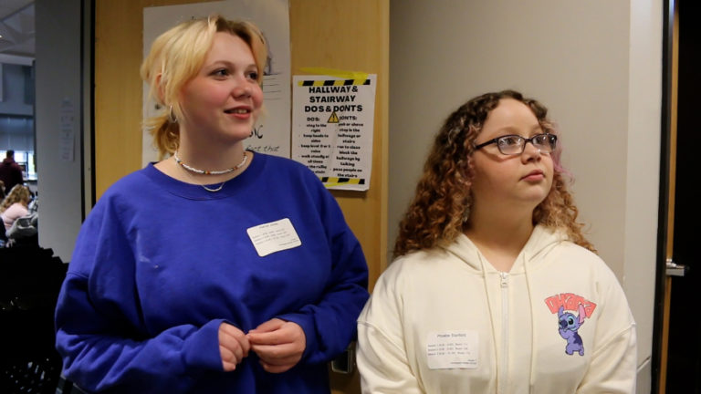 Washougal middle-school students Kenzie Jones (left) and Phoebe Stanford listen to a speech during Jemtegaard Middle School's Career Day event April 19, 2023.