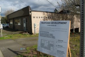 A sign detailing a local business owner's proposal for a mixed-use development on 