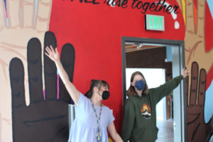 Hayes Freedom High School freshman Kindyl Moore (right) and Hayes Freedom art teacher Miranda Wakeman (left) celebrate the unveiling of their mural inside the Jack, Will and Rob Center on Friday, April 21, 2023. (Photos by Kelly Moyer/Post-Record)