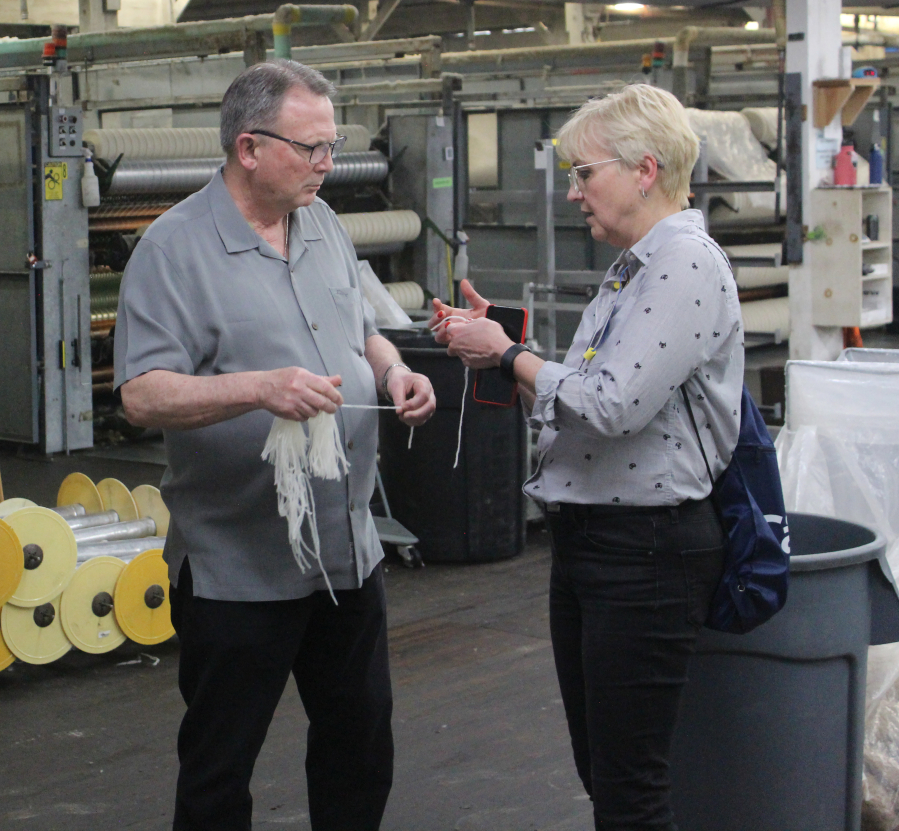 Doug Flanagan/Post-Record 
 Zielonki, Poland resident Roma Toft (right) chats with Rolan Snider, Pendleton Woolen Mills' vice president of textile manufacturing, during a factory tourr on Wednesday, April 26. (Photos by Doug Flanagan/Post-Record)