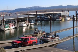 A man lowers his boat into the Columbia River at Parker?s Landing Marina in February 2021. (Doug Flanagan/Post-Record)