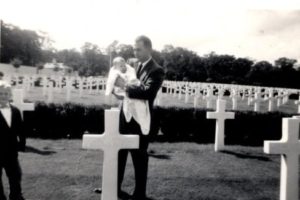 John Reynolds, a 1942 Camas High graduate, holds his infant daughter, Christina, while visiting his brother Arthur Reynolds' gravesite at the Cambridge American Cemetery and Memorial in 
Coton, England. Arthur Reynolds, also a Camas High graduate and member of the 1938 CHS wrestling team, was killed Nov. 10, 1943, during World War II, when the Pathfinder plane he was piloting crashed in Brome, England, killing all 13 airmen onboard as well as four road crew workers and a horse on the ground. (Contributed photo courtesy of Christina Reynolds Price) 