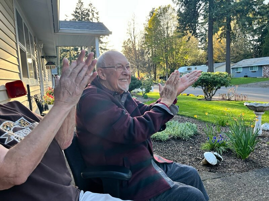 Vancouver resident Ray Johnson applauds April 25, 2023, after a performance by the Washougal High School jazz ensemble at his residence.