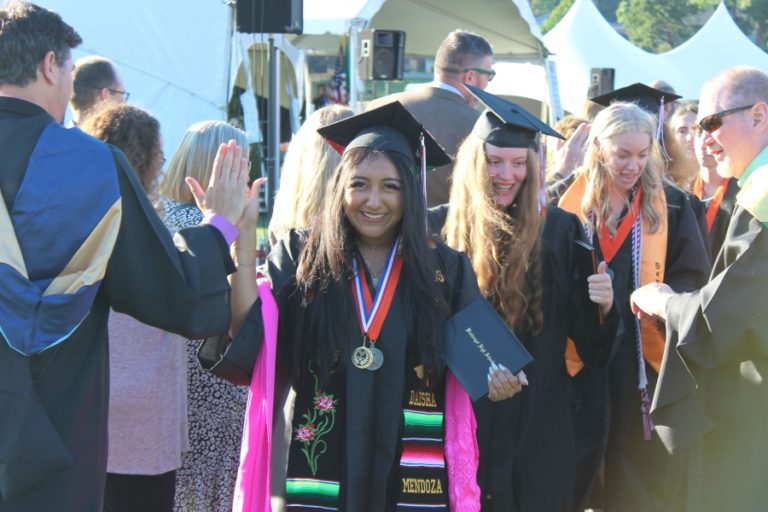 Washougal High School graduates high five after receiving their diplomas on Saturday, June 10, 2023.