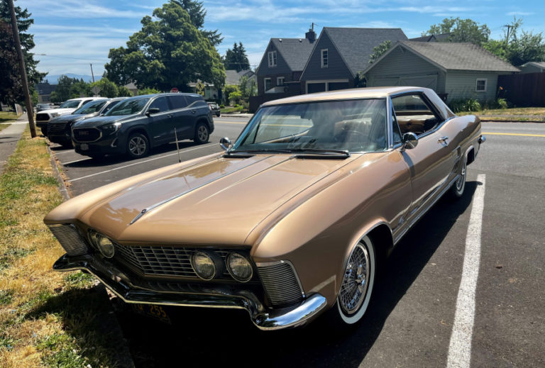 Camas resident Ken Cousins' 1963 Buick Riviera, pictured near Camas' Crown Park on Friday, June 16, 2023, won the 2022 Camas Car Show's "Most Authentic Vintage" award. At top, in a photo courtesy of the Downtown Camas Association, Vintage cars fill downtown Camas streets during the Camas Car Show on Saturday, June 25, 2022.