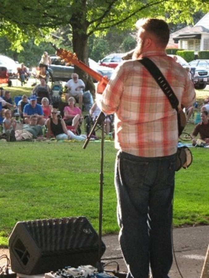 A musician plays for a crowd gathered at Crown Park in July 2022, during Camas' annual Concerts in the Park series.