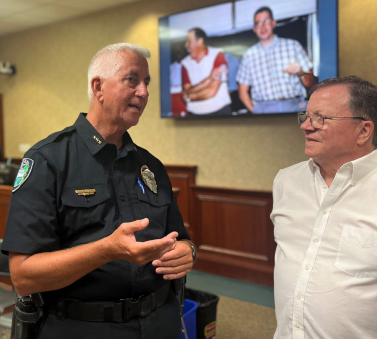 Camas Police Chief Mitch Lackey (left) talks to Camas Mayor Steve Hogan during the police chief's retirement party Friday, June 30, 2023, at Camas City Hall.