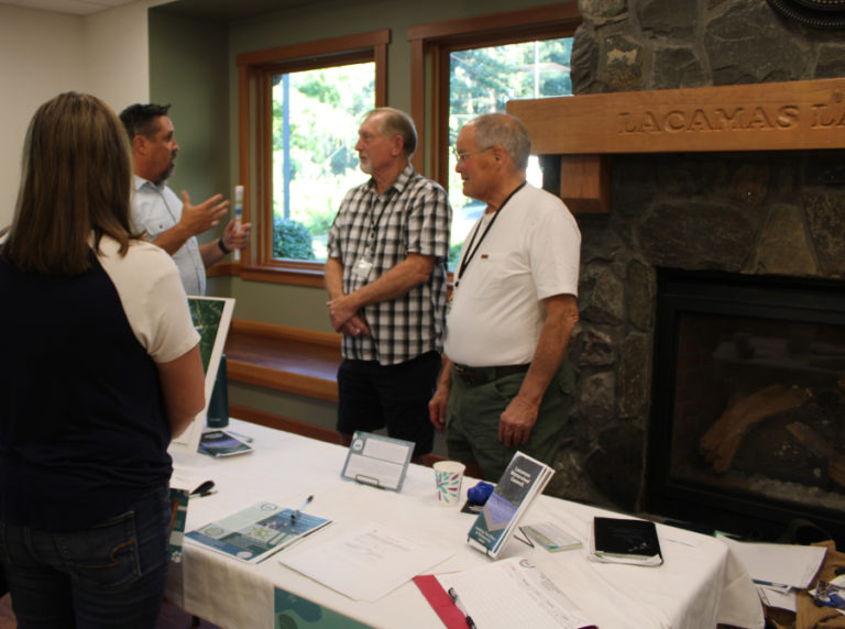 Members of the Lacamas Watershed Council talk to members of the public during a lake water-quality open house held Wednesday, July 12, 2023, at Lacamas Lake Lodge in Camas.