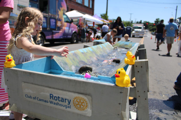 Children play at the Rotary Club of Camas-Washougal's Ducky Derby "duck flume" at the corner of Fourth Avenue and Dallas Street in downtown Camas Friday, July 21, 2023. (Kelly Moyer/Post-Record)