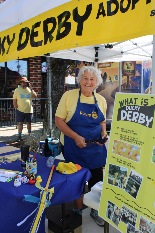 Washougal City Council member and former Washougal Mayor Molly Coston works at the Rotary Club of Camas-Washougal's Ducky Derby booth on Northeast Dallas Street in downtown Camas Friday, July 21, 2023, during the 2023 Camas Days celebration. (Doug Flanagan/Post-Record)
