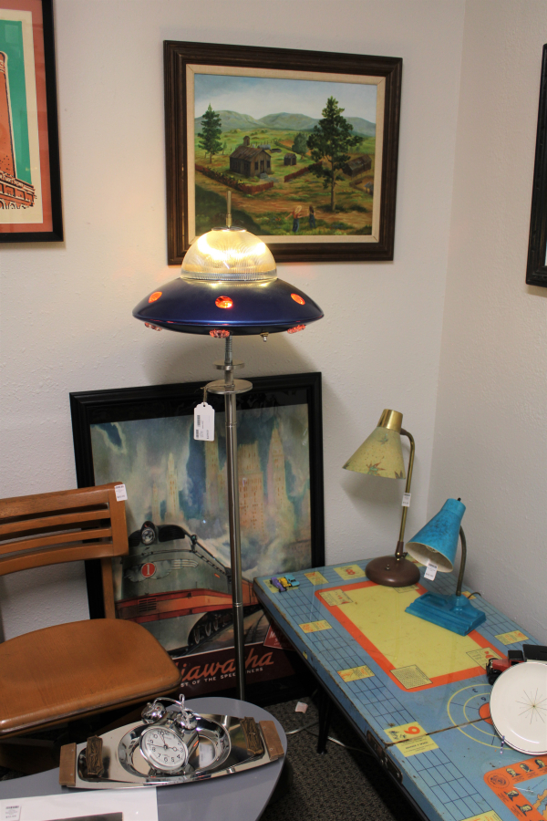 A spaceship lamp by Southwest Washington artist Mike Wilson sits near Wilson's restored furniture and vintage lamps Monday, July 31, 2023, inside the new Bridge Island Arts and Vintage shop in southeast Camas.