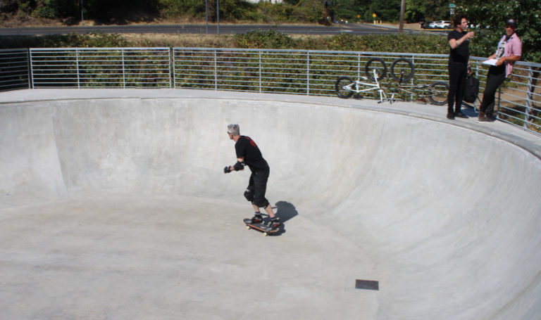 Skateboarder Jeff Mihailoff, of Camas, skates a newly poured concrete bowl Thursday, July 27, 2023, during the grand reopening event celebrating the remodeled Riverside Bowl Skatepark in Camas.