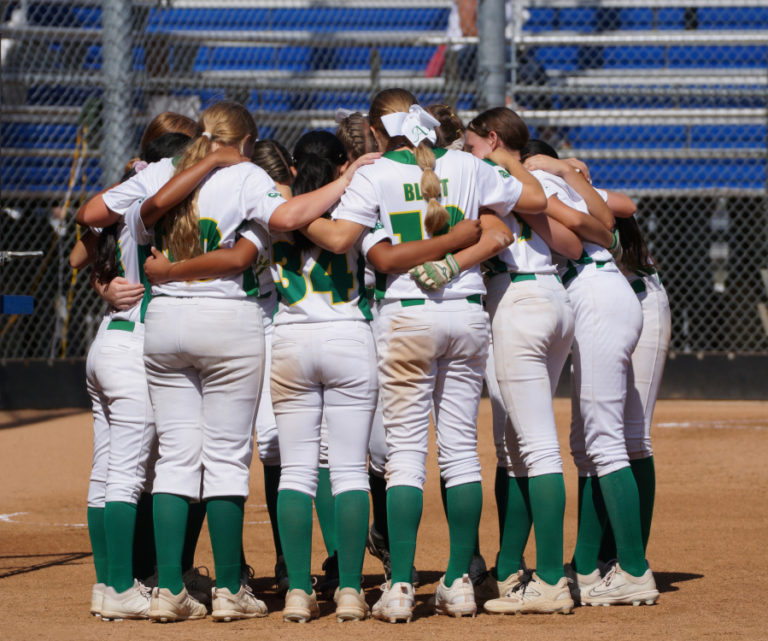 Greenberry Lady A's 12U players huddle during a game earlier this year.