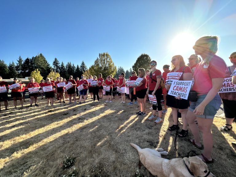 Members of the Camas Education Association, the union representing 450 Camas educators, hold signs showing support for Camas teachers ahead of bargaining negotiations with the Camas School District Wednesday, Aug. 16, 2023.