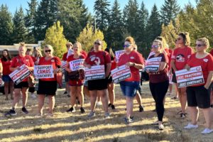 Members of the Camas Education Association, the union representing 450 Camas educators, hold signs showing support for Camas teachers ahead of bargaining negotiations with the Camas School District Wednesday, Aug. 16, 2023. (Contributed photo courtesy of Camas Education Association)